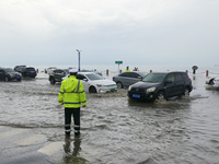 Vehicles are passing a waterlogged section of Binhai Middle Road in Yantai, China, on August 6, 2024. (