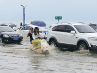 Vehicles are passing a waterlogged section of Binhai Middle Road in Yantai, China, on August 6, 2024. (