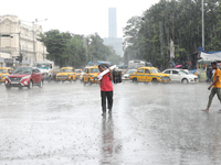 A man is crossing a busy road during heavy monsoon rain in Kolkata, India, on July 07, 2024. (