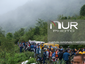 Nepali security forces are carrying the bodies of victims to the hearse from the site of the crashed Air Dynasty Helicopter in Nuwakot Distr...