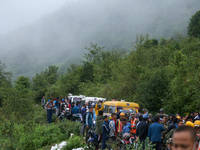 Nepali security forces are carrying the bodies of victims to the hearse from the site of the crashed Air Dynasty Helicopter in Nuwakot Distr...