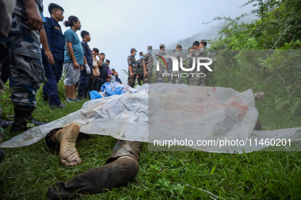 GRAPHIC WARNING: Dead bodies of the Chinese passengers on board the Air Dynasty Helicopter are being covered with plastic sheets near the cr...