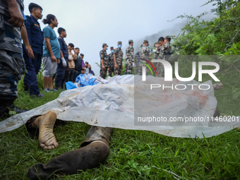 GRAPHIC WARNING: Dead bodies of the Chinese passengers on board the Air Dynasty Helicopter are being covered with plastic sheets near the cr...