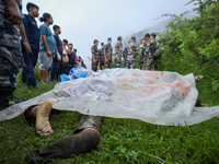 GRAPHIC WARNING: Dead bodies of the Chinese passengers on board the Air Dynasty Helicopter are being covered with plastic sheets near the cr...