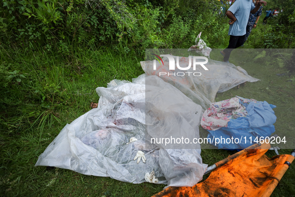 GRAPHIC WARNING: Dead bodies of the Chinese passengers on board the Air Dynasty Helicopter are being covered with plastic sheets near the cr...