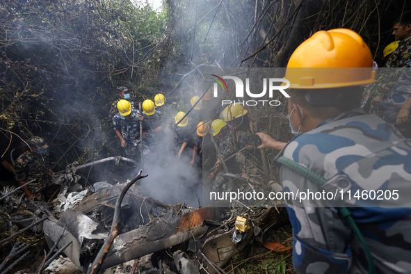 Members of the Nepal Armed Police Force and Nepal Army are searching for the bodies of victims of the Air Dynasty Helicopter crash in Nuwako...