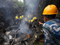 Members of the Nepal Armed Police Force and Nepal Army are searching for the bodies of victims of the Air Dynasty Helicopter crash in Nuwako...