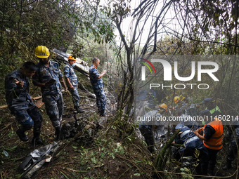 Members of the Nepal Armed Police Force and Nepal Police are searching the wreckage of the Air Dynasty Helicopter that crashed in Nuwakot Di...