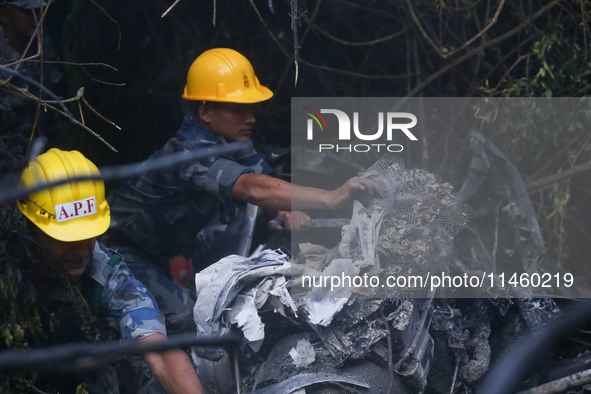 Members of the Nepal Armed Police Force and Nepal Police are searching the wreckage of the Air Dynasty Helicopter that crashed in Nuwakot Di...