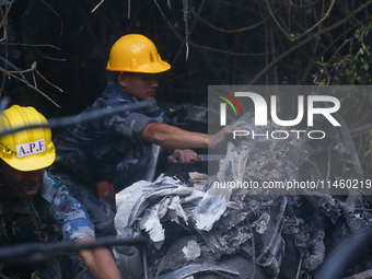 Members of the Nepal Armed Police Force and Nepal Police are searching the wreckage of the Air Dynasty Helicopter that crashed in Nuwakot Di...