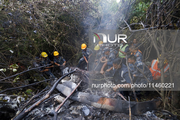 Members of the Nepal Armed Police Force and Nepal Police are searching the wreckage of the Air Dynasty Helicopter that crashed in Nuwakot Di...