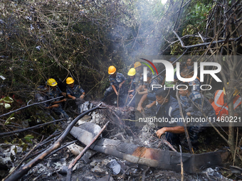 Members of the Nepal Armed Police Force and Nepal Police are searching the wreckage of the Air Dynasty Helicopter that crashed in Nuwakot Di...