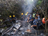 Members of the Nepal Armed Police Force and Nepal Police are searching the wreckage of the Air Dynasty Helicopter that crashed in Nuwakot Di...