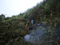 Members of the Nepal Armed Police Force and Nepal Police are searching the wreckage of the Air Dynasty Helicopter that crashed in Nuwakot Di...