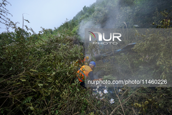 Members of the Nepal Armed Police Force and Nepal Police are searching the wreckage of the Air Dynasty Helicopter that crashed in Nuwakot Di...