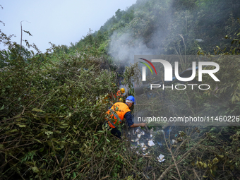 Members of the Nepal Armed Police Force and Nepal Police are searching the wreckage of the Air Dynasty Helicopter that crashed in Nuwakot Di...