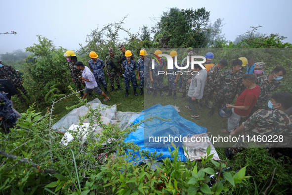 GRAPHIC WARNING: Dead bodies of the Chinese passengers on board the Air Dynasty Helicopter are being covered with plastic sheets near the cr...