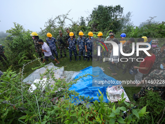 GRAPHIC WARNING: Dead bodies of the Chinese passengers on board the Air Dynasty Helicopter are being covered with plastic sheets near the cr...