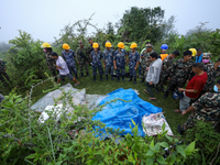 GRAPHIC WARNING: Dead bodies of the Chinese passengers on board the Air Dynasty Helicopter are being covered with plastic sheets near the cr...