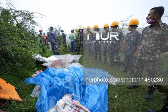 GRAPHIC WARNING: Dead bodies of the Chinese passengers on board the Air Dynasty Helicopter are being covered with plastic sheets near the cr...