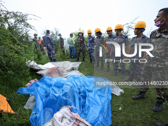 GRAPHIC WARNING: Dead bodies of the Chinese passengers on board the Air Dynasty Helicopter are being covered with plastic sheets near the cr...