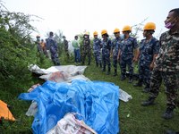 GRAPHIC WARNING: Dead bodies of the Chinese passengers on board the Air Dynasty Helicopter are being covered with plastic sheets near the cr...