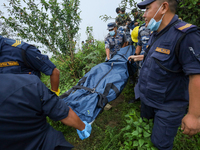 Nepali security forces are carrying the bodies of victims to the hearse from the site of the crashed Air Dynasty Helicopter in Nuwakot Distr...