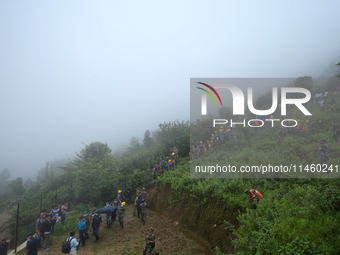 Nepali security forces are carrying the bodies of victims to the hearse from the site of the crashed Air Dynasty Helicopter in Nuwakot Distr...