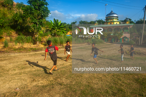 On August 06, 2024, the children of the Matfa village (Majelis Taqlim Fardhu Ain) area are playing football in Langkat, North Sumatra, Indon...