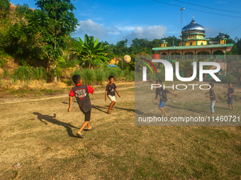 On August 06, 2024, the children of the Matfa village (Majelis Taqlim Fardhu Ain) area are playing football in Langkat, North Sumatra, Indon...