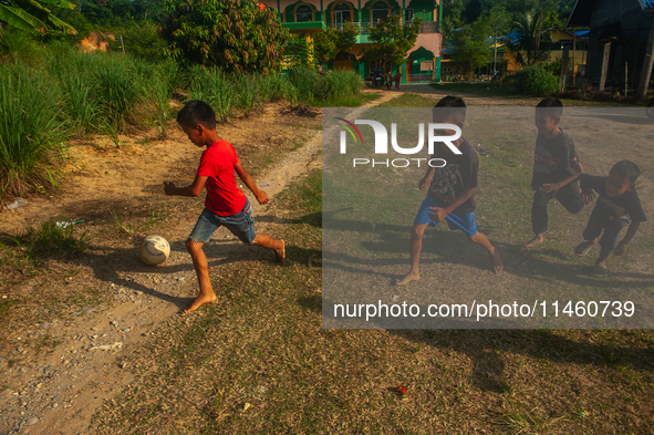 On August 06, 2024, the children of the Matfa village (Majelis Taqlim Fardhu Ain) area are playing football in Langkat, North Sumatra, Indon...