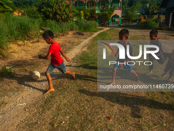 On August 06, 2024, the children of the Matfa village (Majelis Taqlim Fardhu Ain) area are playing football in Langkat, North Sumatra, Indon...