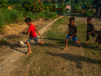 On August 06, 2024, the children of the Matfa village (Majelis Taqlim Fardhu Ain) area are playing football in Langkat, North Sumatra, Indon...