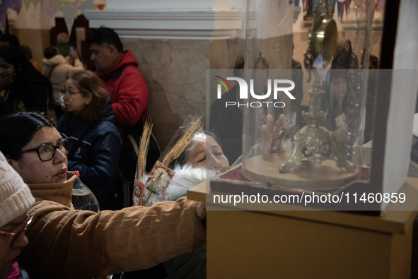 A crowd is leaving the Buenos Aires neighborhood of Liniers as part of the celebration of the day of San Cayetano, the patron saint of bread...