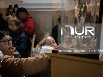 A crowd is leaving the Buenos Aires neighborhood of Liniers as part of the celebration of the day of San Cayetano, the patron saint of bread...