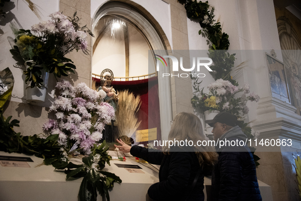 A crowd is leaving the Buenos Aires neighborhood of Liniers as part of the celebration of the day of San Cayetano, the patron saint of bread...