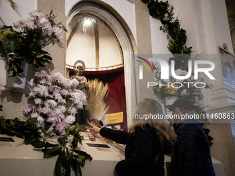 A crowd is leaving the Buenos Aires neighborhood of Liniers as part of the celebration of the day of San Cayetano, the patron saint of bread...