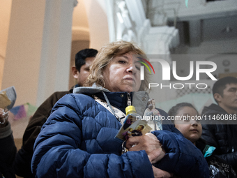 A crowd is leaving the Buenos Aires neighborhood of Liniers as part of the celebration of the day of San Cayetano, the patron saint of bread...