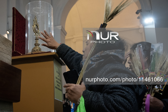 A crowd is leaving the Buenos Aires neighborhood of Liniers as part of the celebration of the day of San Cayetano, the patron saint of bread...