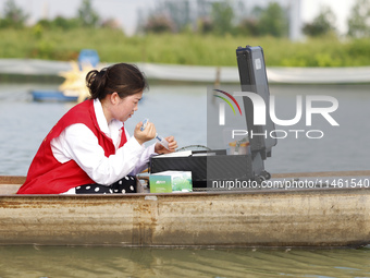 Aquaculture technicians are testing water quality at a crab pond in Wanggou village in Suqian, Jiangsu province, China, on August 7, 2024. (