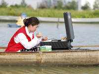 Aquaculture technicians are testing water quality at a crab pond in Wanggou village in Suqian, Jiangsu province, China, on August 7, 2024. (