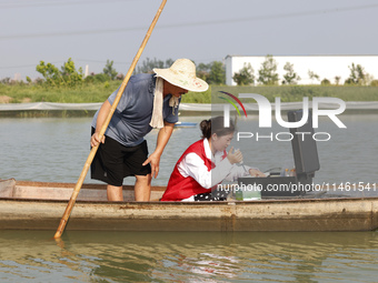 Aquaculture technicians are testing water quality at a crab pond in Wanggou village in Suqian, Jiangsu province, China, on August 7, 2024. (