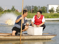 Aquaculture technicians are testing water quality at a crab pond in Wanggou village in Suqian, Jiangsu province, China, on August 7, 2024. (