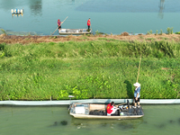 Aquaculture technicians are testing water quality at a crab pond in Wanggou village in Suqian, Jiangsu province, China, on August 7, 2024. (