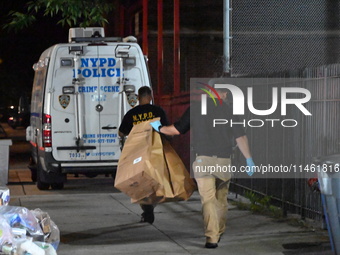 Crime scene investigators from the New York City police department are on scene investigating human remains found and are bringing out evide...