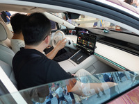 People are experiencing the HIMA S9 new electric sedan at the Huawei Store in Wangfujing in Beijing, China, on August 8, 2024. (