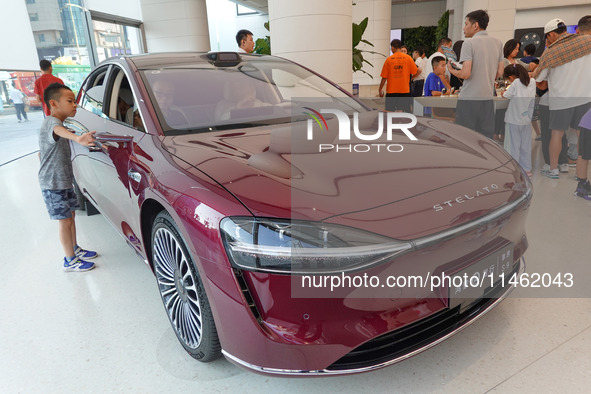 People are experiencing the HIMA S9 new electric sedan at the Huawei Store in Wangfujing in Beijing, China, on August 8, 2024. 