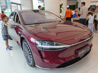 People are experiencing the HIMA S9 new electric sedan at the Huawei Store in Wangfujing in Beijing, China, on August 8, 2024. (