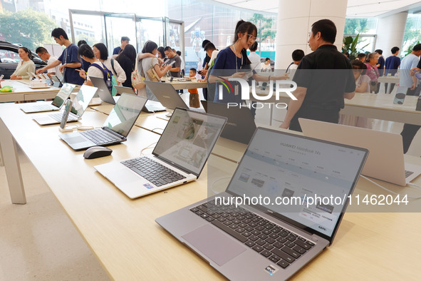 People are experiencing Huawei products at the Huawei store in Wangfujing, Beijing, China, on August 8, 2024. 