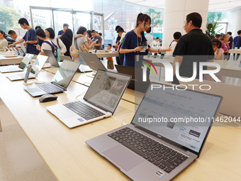 People are experiencing Huawei products at the Huawei store in Wangfujing, Beijing, China, on August 8, 2024. (